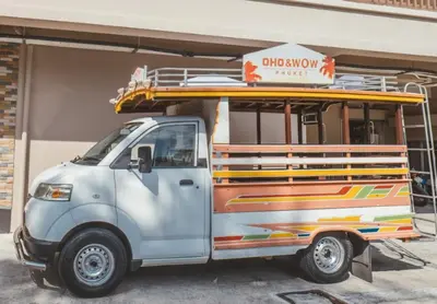 a small white truck parked in front of a building at WOW PHUKET in Phuket Town