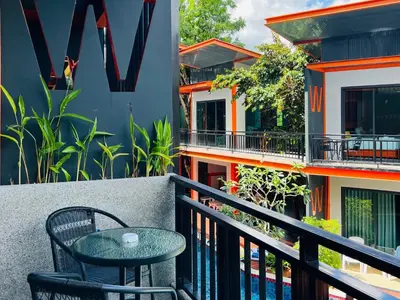 a table and chair sitting on a balcony at WOW PHUKET in Phuket Town