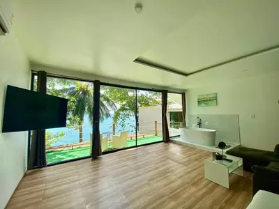 a large living room with a tub and a tv at patong sunset villa Phuket in Patong Beach
