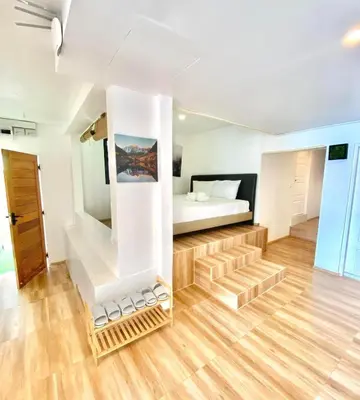 a room with a bed and stairs leading to a bedroom at patong sunset villa Phuket in Patong Beach