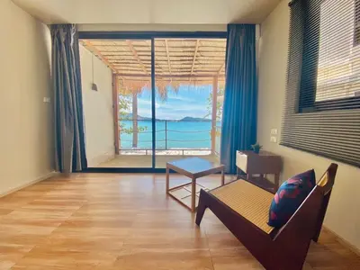 a living room with a couch and a view of the ocean at patong sunset villa Phuket in Patong Beach
