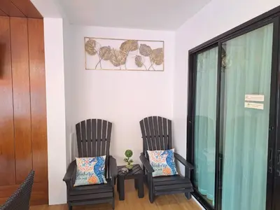 two chairs and a table in a room at The Chic Pool Villa in Nai Yang Beach