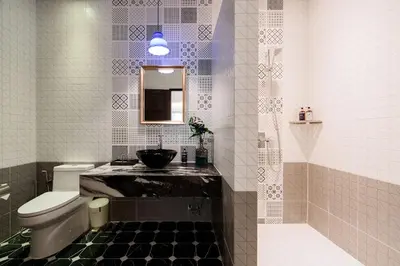 a bathroom with a toilet and a sink and a mirror at Sabai Hotel Aonang in Ao Nang Beach