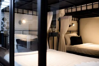 a bedroom with two bunk beds and a window at Sabai Hotel Aonang in Ao Nang Beach