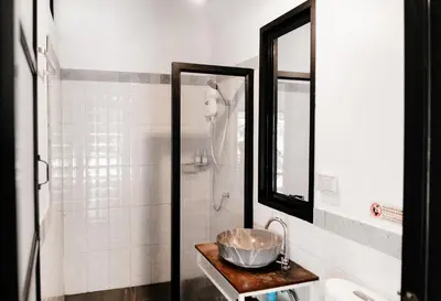 a bathroom with a sink and a shower at Kunna House in Ko Yao Noi