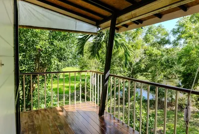 a screened porch with a view of the trees at Kunna House in Ko Yao Noi