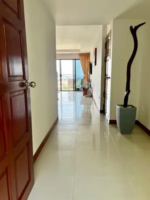 a hallway with a door and a tree sculpture in it at Mountain Seaview Luxury Apartments in Kata Beach