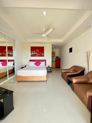 a bedroom with a bed and a couch at Mountain Seaview Luxury Apartments in Kata Beach