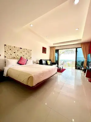a bedroom with a large bed and a large window at Mountain Seaview Luxury Apartments in Kata Beach