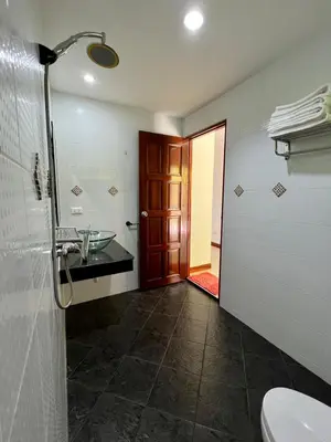 a bathroom with a toilet and a sink and a door at Mountain Seaview Luxury Apartments in Kata Beach