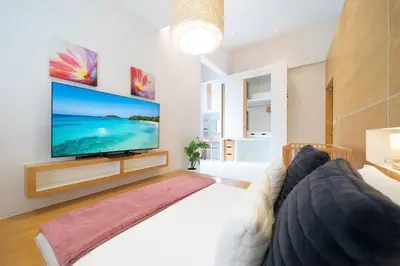 a living room with a large flat screen tv at Villa Casa Koko - Luxury Modern Minimalism in Thalang