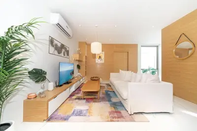 a living room with a white couch and a table at Villa Casa Koko - Luxury Modern Minimalism in Thalang