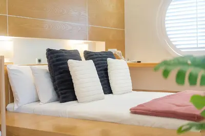 a white bed with black and white pillows on it at Villa Casa Koko - Luxury Modern Minimalism in Thalang