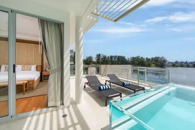 a house with a swimming pool and a bedroom at Beachfront Residences - Stunning Sea and Lake View in Bang Tao Beach