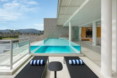 a swimming pool on the balcony of a house at Beachfront Residences - Stunning Sea and Lake View in Bang Tao Beach