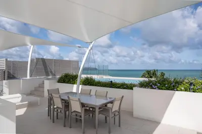 a patio with a table and chairs and the ocean at Beachfront Residences - Stunning Sea and Lake View in Bang Tao Beach