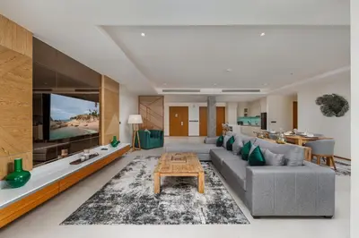 a living room with a couch and a table at Beachfront Residences - Stunning Sea and Lake View in Bang Tao Beach