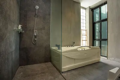 a bathroom with a tub and a sink and a shower at Villa Jeanne in Kamala Beach