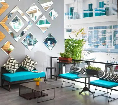 a room with chairs and tables and windows at The Crib Patong - SHA Certified in Patong Beach