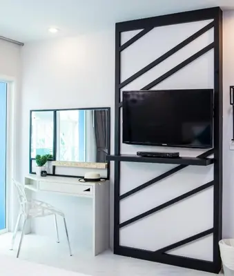 a sliding barn door in a living room with a tv at The Crib Patong - SHA Certified in Patong Beach