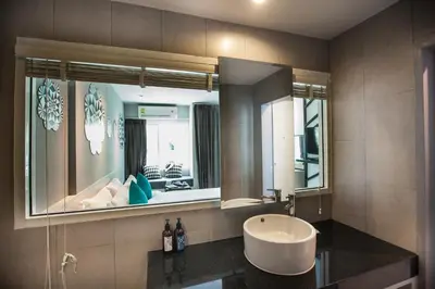 a bathroom with a sink and a mirror at The Crib Patong - SHA Certified in Patong Beach