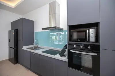 a kitchen with a sink and a microwave at amazing new brand 3 bedrooms pool villa at rawai in Rawai Beach