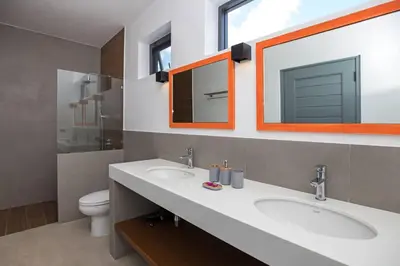 a bathroom with two sinks and a mirror and a toilet at amazing new brand 3 bedrooms pool villa at rawai in Rawai Beach