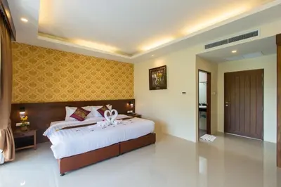 a bedroom with a large bed with white sheets at The Casita Phuket (SHA+) in Mai Khao Beach