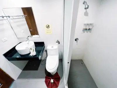 a bathroom with a toilet and a sink at The Casita Phuket (SHA+) in Mai Khao Beach