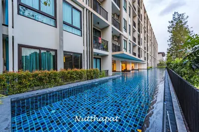 a swimming pool in front of a building at Chic & Sweet, Pool view, Prime location near beach in Phuket Town