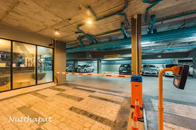 a parking lot with cars in a garage at Chic & Sweet, Pool view, Prime location near beach in Phuket Town