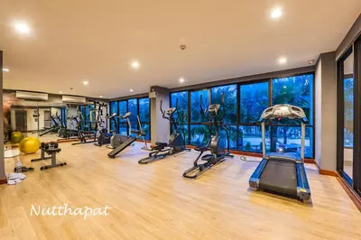 a gym with treadmills and elliptical machines at Chic & Sweet, Pool view, Prime location near beach in Phuket Town