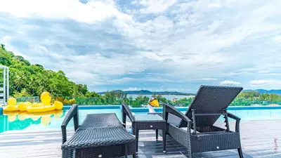 a patio with two chairs and a swimming pool at The Aristo-2-903 in Surin Beach