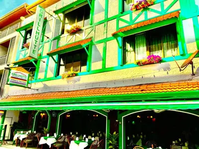 a building with tables and chairs in front of it at Grillhütte Patong in Patong Beach