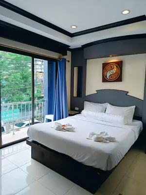 a bedroom with a large bed and a balcony at Hill View Lodge in Patong Beach