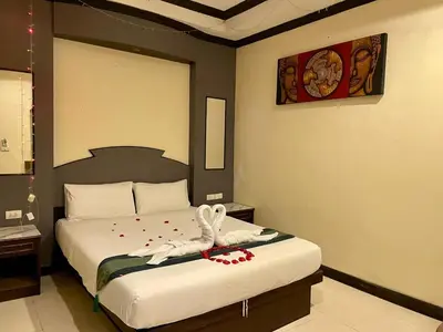 a bedroom with a bed with a towel on it at Hill View Lodge in Patong Beach