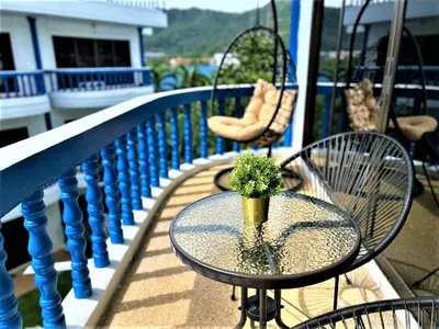 a glass table with a plant on a balcony at Kamala - The Club Residence -2 BR Pool View Residence in Kamala Beach