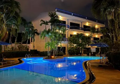a swimming pool in front of a building at night at Kamala - The Club Residence -2 BR Pool View Residence in Kamala Beach