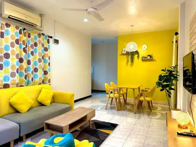 a living room with a couch and a table at 1BR Cozy House, Bangtao Beach in Ban Thalat Choeng Thale
