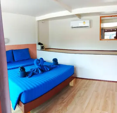 a bedroom with a blue bed with a blue ribbon at Blue View House Phi Phi in Phi Phi Don