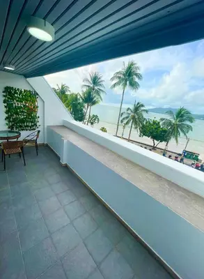 a balcony with a view of the ocean and palm trees at Garden Beach Sea View Patong in Patong Beach