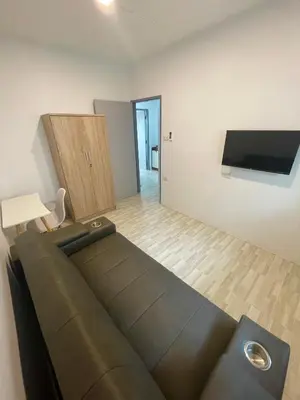 a living room with a couch and a flat screen tv at Garden Beach Sea View Patong in Patong Beach