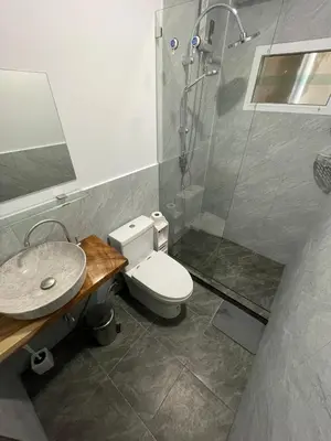 a bathroom with a shower and a toilet and a sink at Garden Beach Sea View Patong in Patong Beach