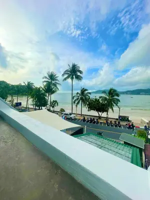 a view of a beach with palm trees and the water at Garden Beach Sea View Patong in Patong Beach