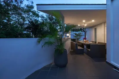 a patio with a table and a potted plant at 3BR Villa Marine with Private Pool, Waterfalls in NaiHarn Beach in Rawai Beach