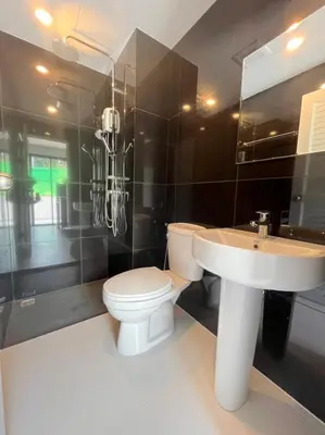 a bathroom with a toilet and a sink at VIP Great Hill Phuket Airport in Phuket Town