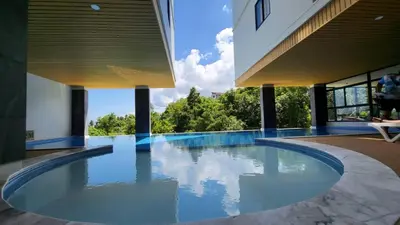 a swimming pool in the middle of a building at VIP Great Hill Phuket Airport in Phuket Town