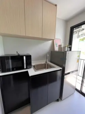 a kitchen with a sink and a microwave at VIP Great Hill Phuket Airport in Phuket Town