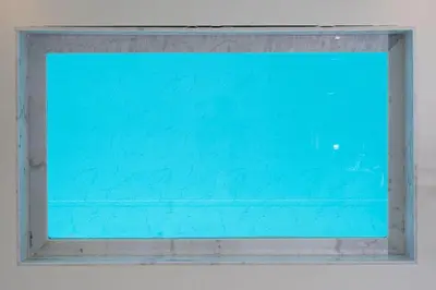 a window in a white wall with blue glass at seaview villa private swimming pool in Karon Beach