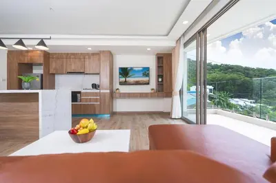 an open kitchen and dining room with a large window at seaview villa private swimming pool in Karon Beach